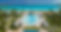 Upscale pool area in an Exuma resort, adorned with lounge chairs and umbrellas, nestled am